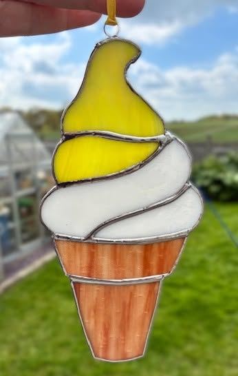 A stained glass lemon suncatcher in yellow and green glass